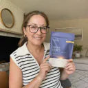 Customer holding an Orela Night Reset pouch at home