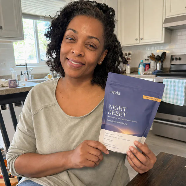 Customer holding Orela Night Reset pouch in a kitchen